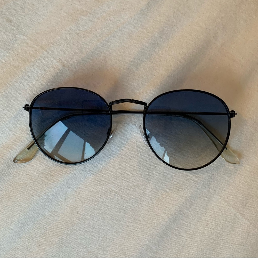 Vintage black sunglasses with blue-tinted lens